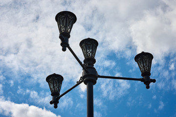 Street light hanging on power pole isolated on blue sky background. The lamp on the sky background....