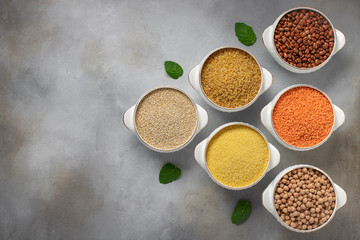 set of raw cereals: bulgur, couscous, beans, quinoa, lentils, chickpeas. copy space, top view, horizontal image