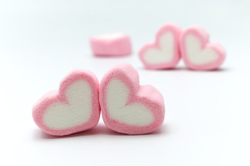 Obraz premium Pink sweet heart shape marshmallow on white background.