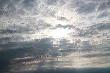 Evening landscape with sky, clouds, sun and sunbeams.