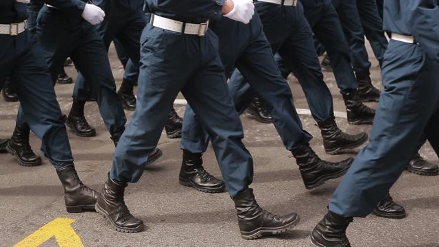 A close-up of the feet of military men who march on the parade . Same clothes and shoes in public. Military march close-up in slowmotion shooting.