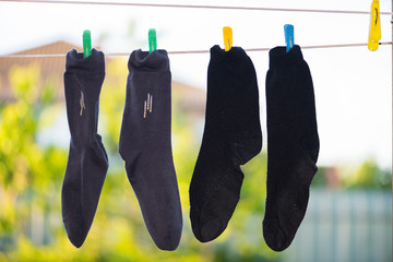 Socks dry on a clothesline outside after washing