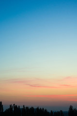 Landscape with dramatic light - beautiful golden sunset with saturated sky and clouds.