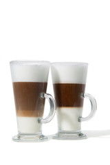 Two classes of caffe with milk on white background
