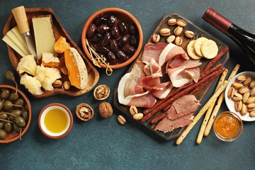 Appetizers table concept. Tapas and wein on dark blue background. Flat layot