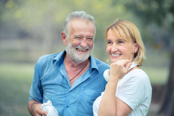 Happy senior couple in love relaxing in the park together.