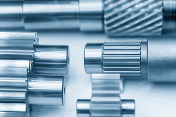 The close-up scene of various type of  the pinion gear parts shaft  in the light blue scene. The...