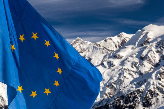Beautiful view from the ski slopes in snow-caped mountains and the European flag.