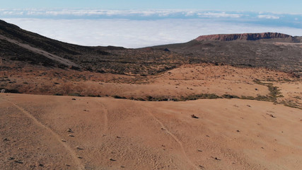 Fototapeta na wymiar Aerial view of empty and lifeless desert landscape near a volcano. Lunar or Martian view. Teide National Park, Tenerife, Canary Islands, Spain