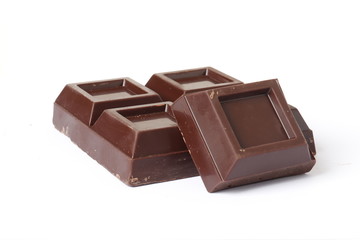 Dark chocolate pieces on white background