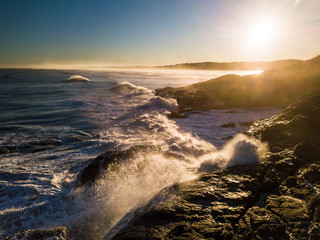 Aerial view crashing waves on rugged shoreline