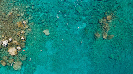 Aerial view sea with tourists swimming in beautiful clear turquoise water
