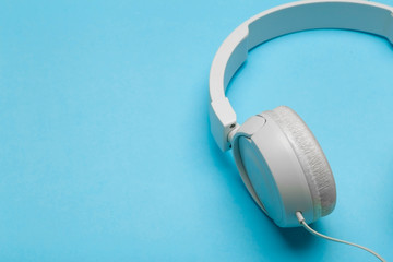 Musical headphones on a colored blue background. Aesthetics retro 80s and minimal concept