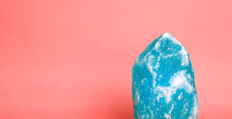 Blue mineral on a pink background. Minimal concept