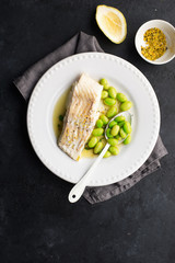 Fishplate. Sea white cod fish with a side dish of vegetables and mushrooms on a plate. Top view