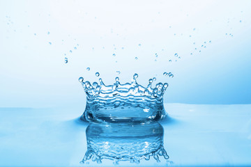 Close up macro of splash of falling drops of water and impact to a other drop of water and form...
