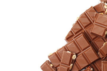 A bar and pieces of milk chocolate isolated on a white background. top view