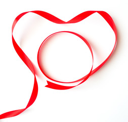Valentine concept, Isolated red heart ribbon decorated on white table background-top view
