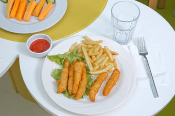 crunchy fried chicken . Schnitzel with french fries and salad . fried chicken and french fries on a wooden background .