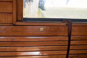 Empty wooden seat with a number twenty-one in a compartment of a vintage train