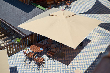 Bird's eye view of garden furniture under a parasol on a sunny day © branislav