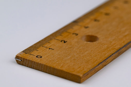 A wooden ruler on a white table
