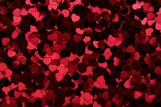 Sparkling hearts. Heart shape red glitter bright background. Flat lay. Love symbol, Valentine's Day holiday greeting card.
