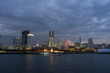 Naklejka na ściany i meble Cityscape of Yokohama MinatoMirai in Yokohama City Japan city skyline from the bay at twilight.
