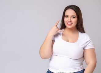 Plus Size Model with long hair Making Call Me Gesture