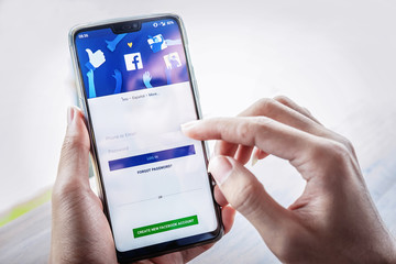 Facebook shop Chiangmai, THAILAND - July 7, 2018: Facebook social media app logo on log-in, sign-up registration page on mobile app screen on Oneplus 6 in person's hand working on e-commerce shopping business