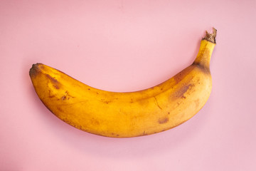 One overripe yellow banana fruit on colour background. Healthy vegetarian food... - 309793212