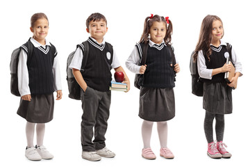 Group of pupils with backpacks wearing a school uniform