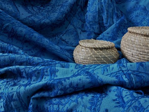 Blue indian arab textile tribal pattern and baskets closeup