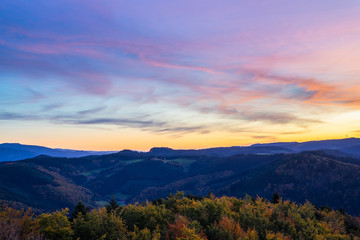 Fototapeta na wymiar Germany, Impressive aerial view above endless beautiful black forest holiday nature landscape above tree tops at sunset in autumn season