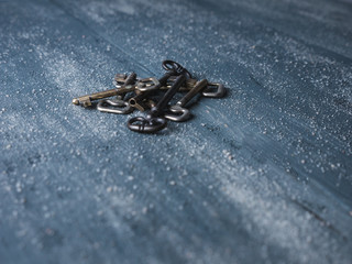 old keys put together on a vintage wooden background