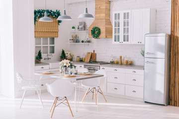 Interior of a bright modern kitchen in vintage style, decorated with Christmas decor