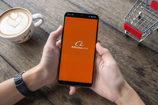 CHIANG MAI, THAILAND - May 11,2019: Man hands holding Oneplus a with alibaba apps on screen. Alibaba the the world biggest online commerce company. Its thAree main sites Taobao,Tmall and Alibaba.