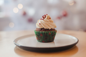 Close up cupcake with christmas tree shape on wooden table. Christmas and new year holidays background concept.