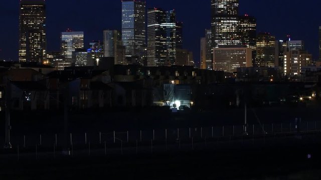 Cinemagraph of Commuter Trains Speed Past Cityscape