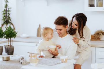Obraz na płótnie Canvas Happy family with children rolling dough in Christmas kitchen.