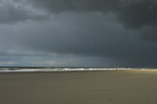 dark clouds over sandy beach Hoek van Holland