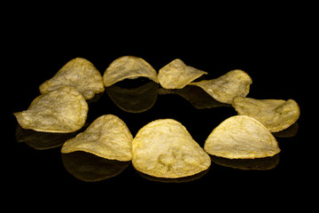 Fototapeta na wymiar Group of nine whole crisp potato chip circle isolated on black glass