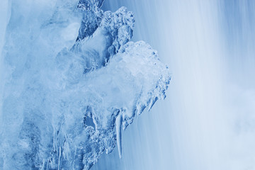 Naklejka na ściany i meble Winter waterfall framed by ice, Comstock Creek, Michigan, USA