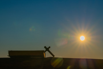 The scriptures on the old oak table Beautiful sunrise light background, religious concept