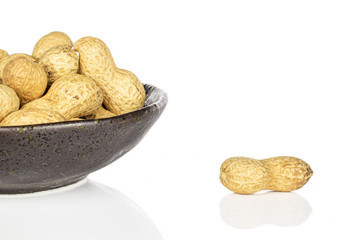 Lot of whole tasty beige peanut in glazed bowl isolated on white background