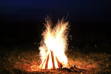 Bonfire with sparks and strong fire at night