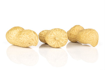 Fototapeta na wymiar Group of three whole tasty beige peanut isolated on white background