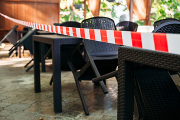 stretched security tape at tables in a street cafe
