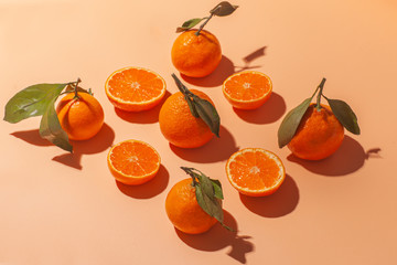 many ripe and sliced juicu orange tangerine isolated on orange background, flat lay pattern