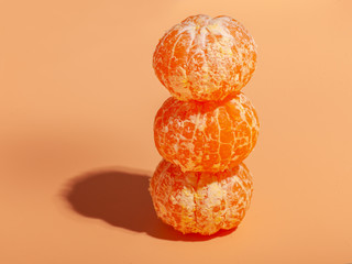 ripe pilled orange mandarin pieces on orange background